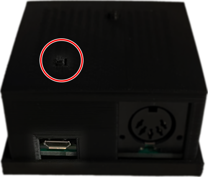 A picture of a Roll Limitless adapter, showing the firmware button circled in red.